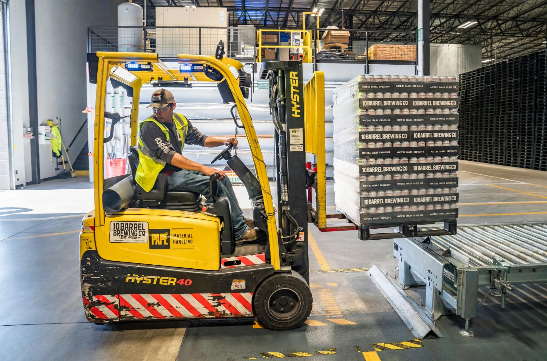 Forklift moving pallets in a warehouse